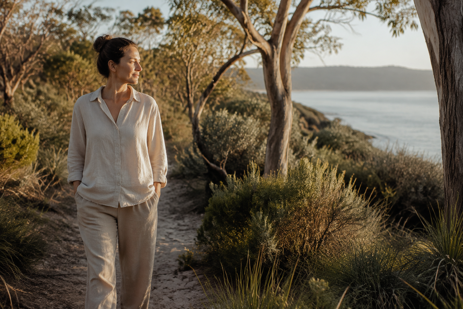 A woman walking peacefully through Australian coastal bushland
